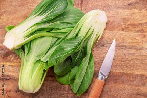 Bild auf Leinwand Bok choy or chinese cabbage on wooden background. View above.