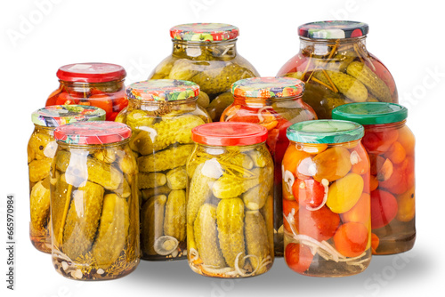 Pickled cucumbers and tomatoes in glass jars. Isolated on a white background.