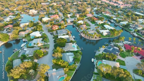 View from above of wealthy neighborhood in Sarasota city, Florida with expensive waterfront houses between green palm trees. Development of US premium housing photo