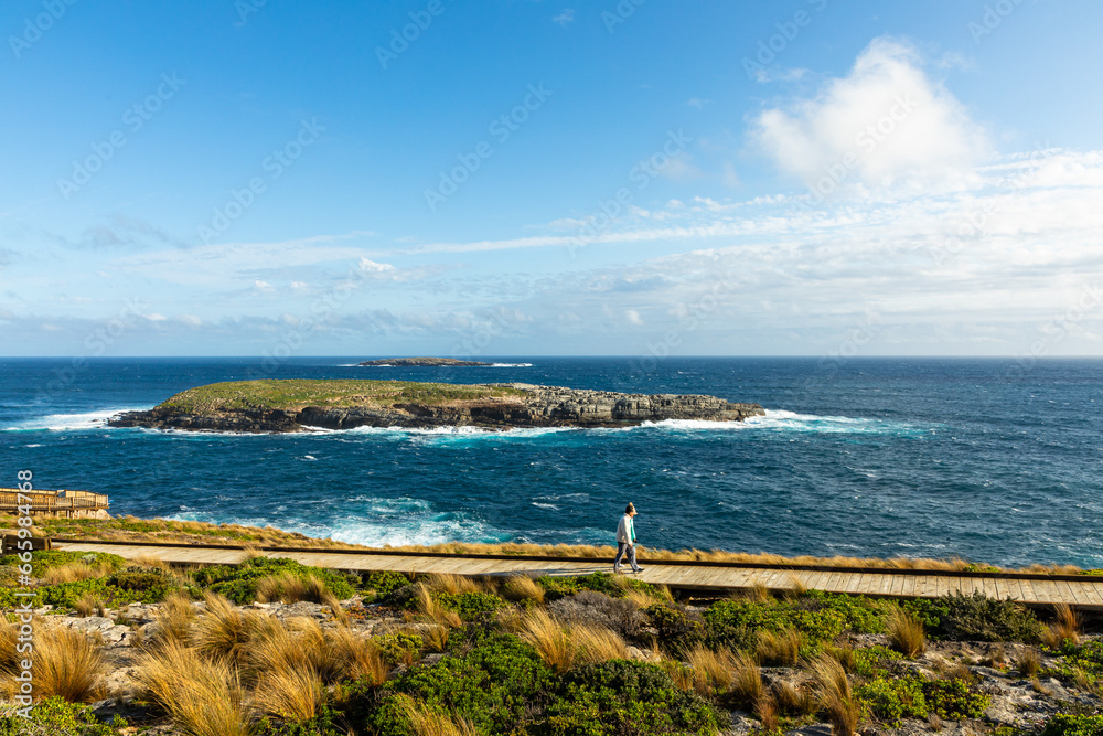 Admirals Arch and Cape Du Couedic Lighthouse with beautiful afternoon sun and blue sky at Kangaroo Island, South Australia