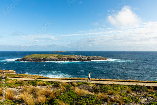 Admirals Arch and Cape Du Couedic Lighthouse with beautiful afternoon sun and blue sky at Kangaroo Island, South Australia
