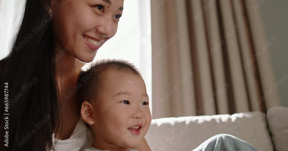 Asian mom and son laughing together. Multiethnic asian mom and son spending time together