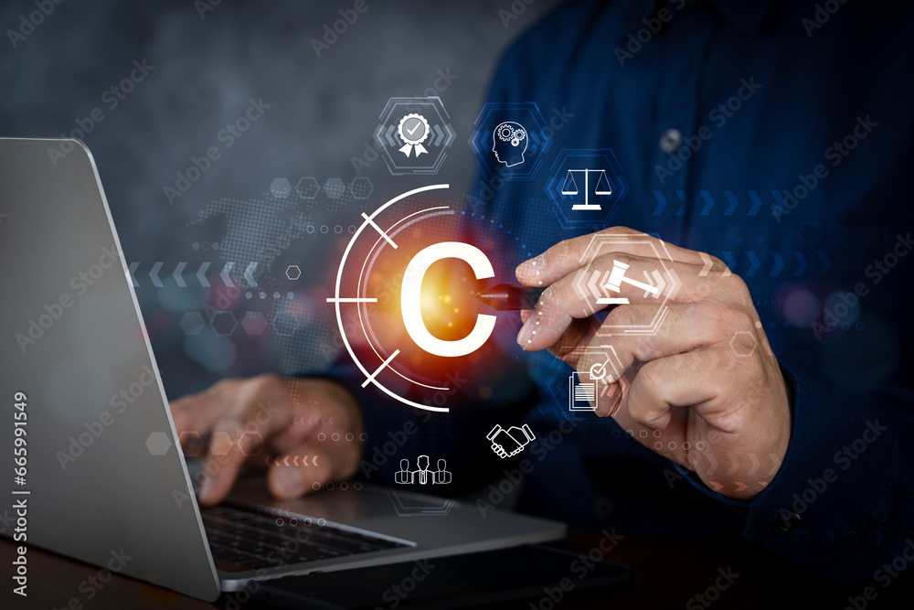 Copyright or patent concept, Person hand using laptop computer on desk with VR screen copyright icon background, Copyleft trademark license. Copyright or patent concept, Person hand using laptop computer on desk with VR screen copyright icon background, Copyleft trademark license.
