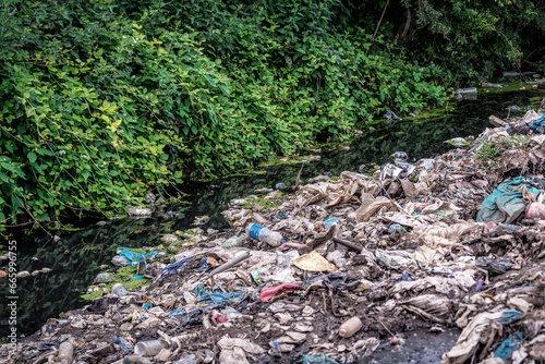River that is polluted with various garbage and trash, Polluted water