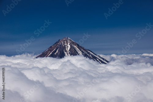 Kamchatka volcanic landscape: view to top of cone of Koryaksky Volcano from scenery active crater of Avacha Volcano on sunny day and blue sky. Russian Far East photo