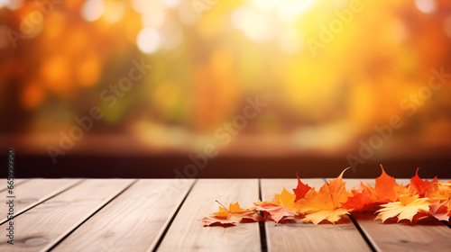 A wooden table set against a dreamy  fall-colored backdrop of crimson and yellow foliage.