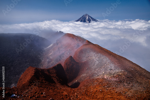 Kamchatka volcanic landscape: view to top of cone of Koryaksky Volcano from scenery active crater of Avacha Volcano on sunny day and blue sky. Russian Far East