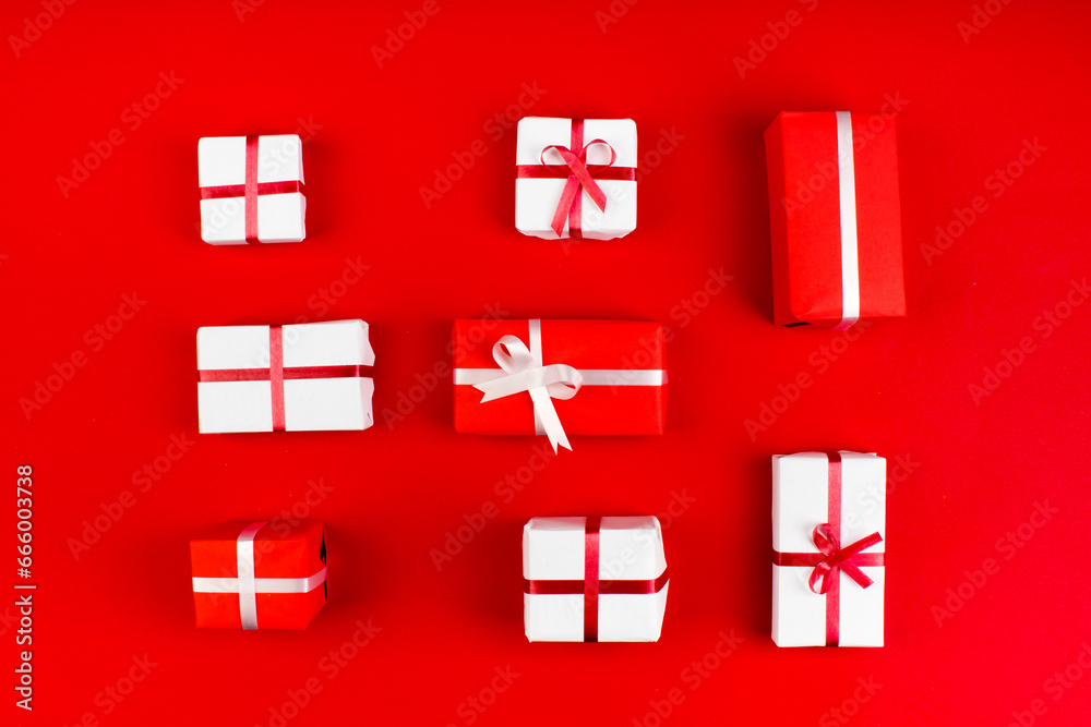 Fototapeta premium Gift boxes and colorful present for christmas on red background. Top view with copy space.