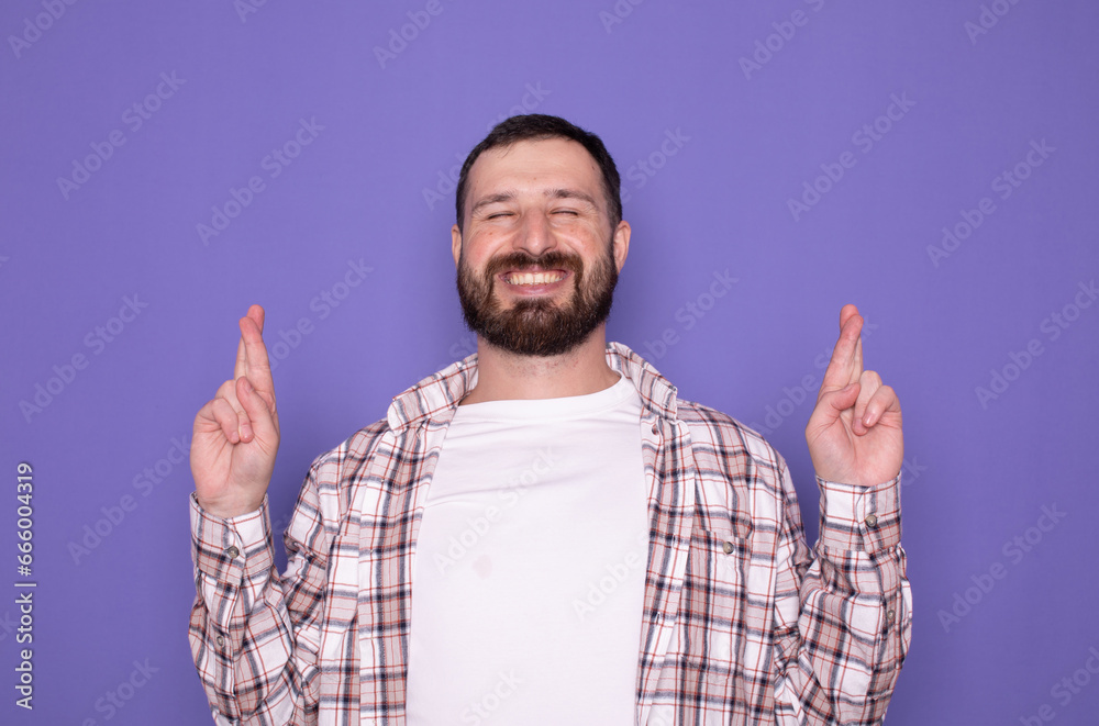 Bearded man making a wish keeping his fingers crossed. Body language. Bearded man making a wish keeping his fingers crossed. Body language.