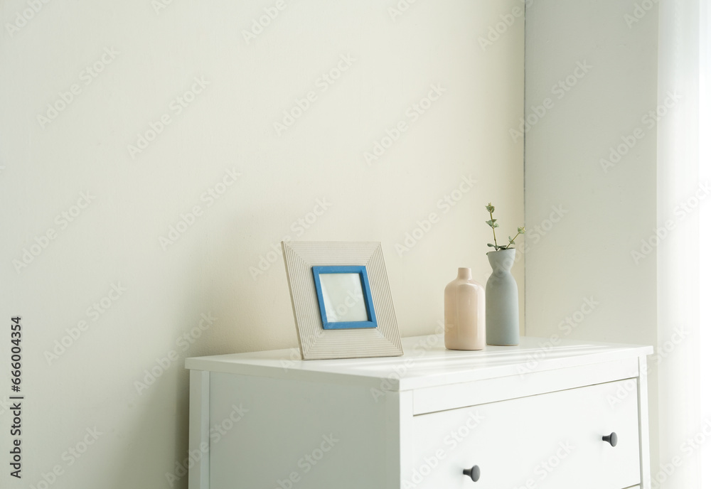 white vase with flowers and frame