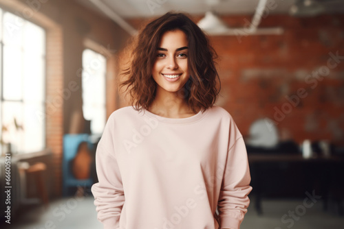 Young blond woman wearing blank soft pink sweatshirt stands in front of camera. Fashion mockup with copy space. Sweatshirt template. Generative AI photo