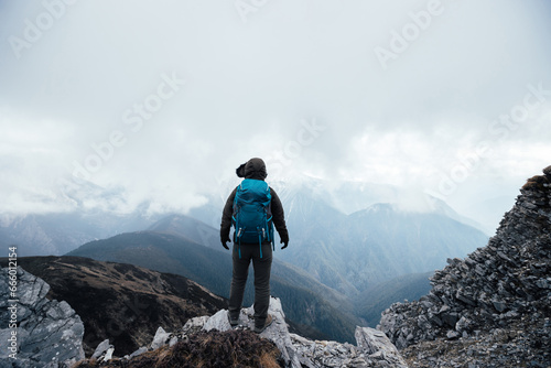 Woman hiker hiking at mountain top in tibet