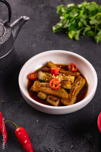 fried eggplant in soy sauce with garlic side view