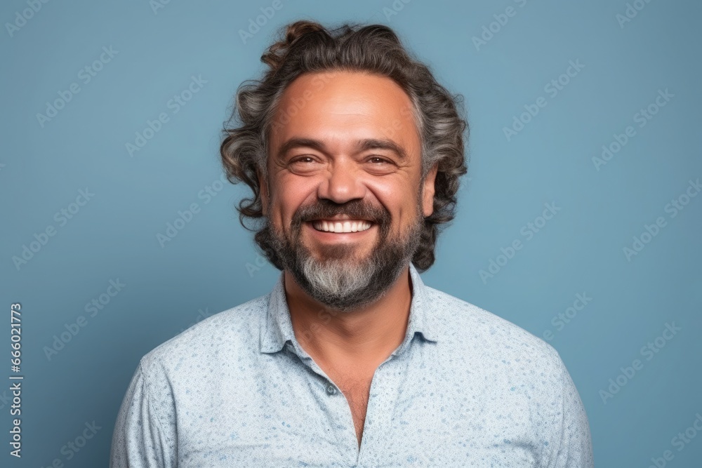 Middle-aged Caucasian man on blue background, cheerful and pleasant. Middle-aged Caucasian man on blue background, cheerful and pleasant.