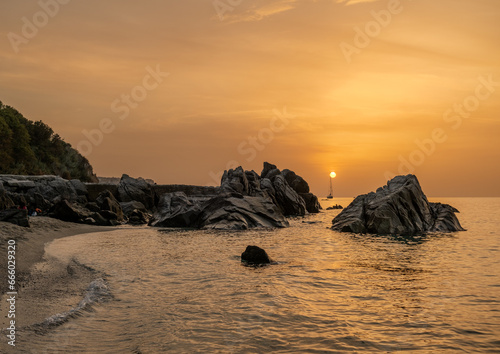 Fototapeta Naklejka Na Ścianę i Meble -  Sunset on the famous Michelino beach with mist on the horizon, Parghelia - Tropea, Vibo Valentia, Calabria, Italy