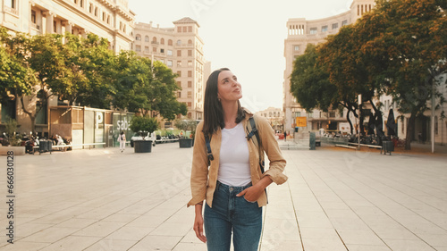 Photography Traveler girl, with backpack on her shoulders, walks in the historical part of E