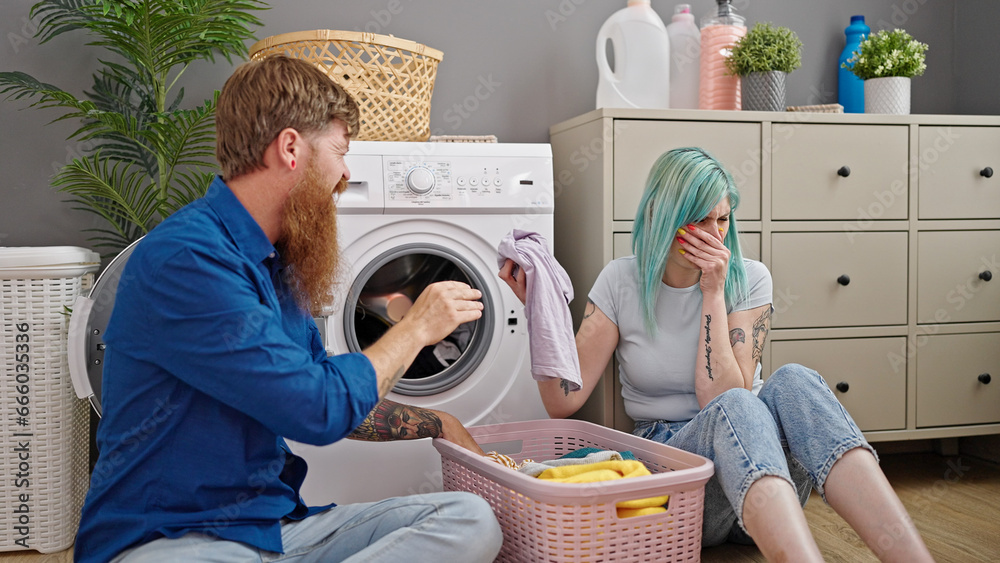 Man and woman couple washing dirty clothes at laundry room Man and woman couple washing dirty clothes at laundry room