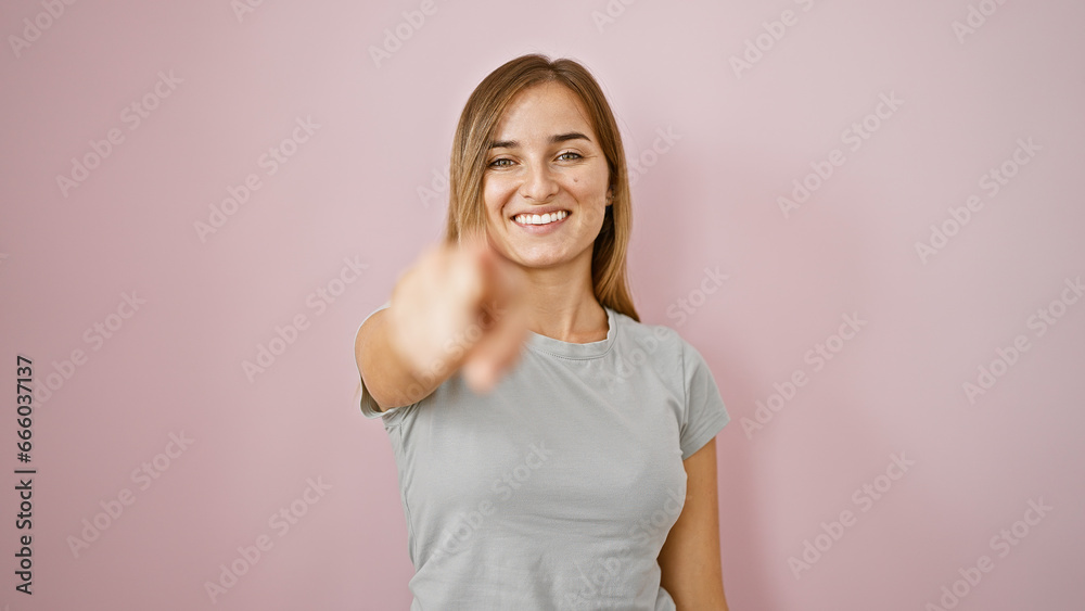 Cheerful young blonde woman soaking up the joy, confidently pointing at you, smiling for the camera, over an isolated fun pink wall - she's positively glowing! Cheerful young blonde woman soaking up the joy, confidently pointing at you, smiling for the camera, over an isolated fun pink wall - she's positively glowing!