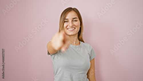 Tablou pe pânză Cheerful young blonde woman soaking up the joy, confidently pointing at you, smi