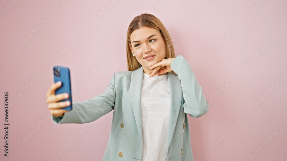 Young blonde woman business worker smiling confident make selfie by smartphone over isolated pink background Young blonde woman business worker smiling confident make selfie by smartphone over isolated pink background