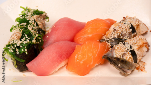 Sushi with salmon, eel, tuna, hiyashi wakame, sesame isolated. photo