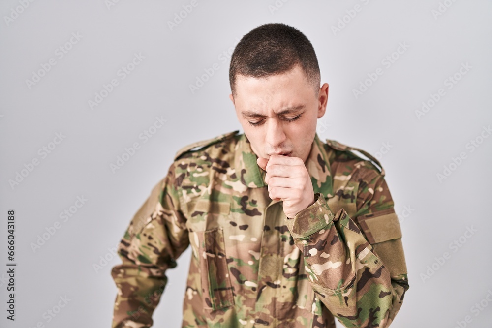 Young man wearing camouflage army uniform feeling unwell and coughing as symptom for cold or bronchitis. health care concept.