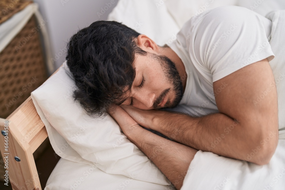 Young hispanic man lying on bed sleeping at bedroom Young hispanic man lying on bed sleeping at bedroom