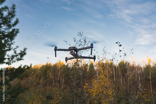 Quadcopter with camera in the air in nature in autumn.
