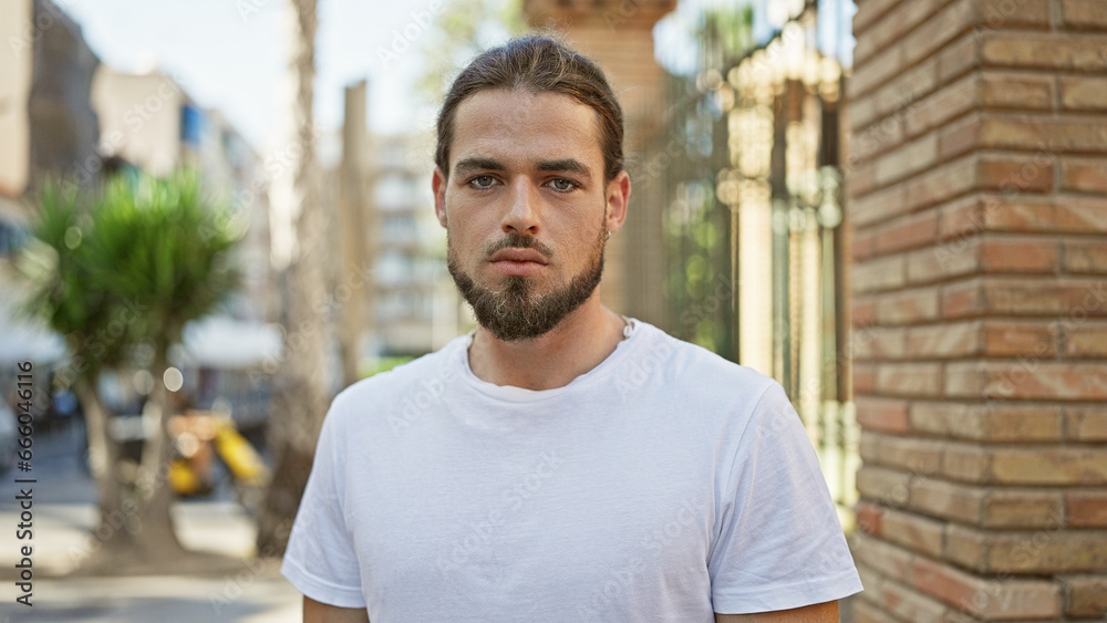 Young hispanic man standing with serious expression at street Young hispanic man standing with serious expression at street