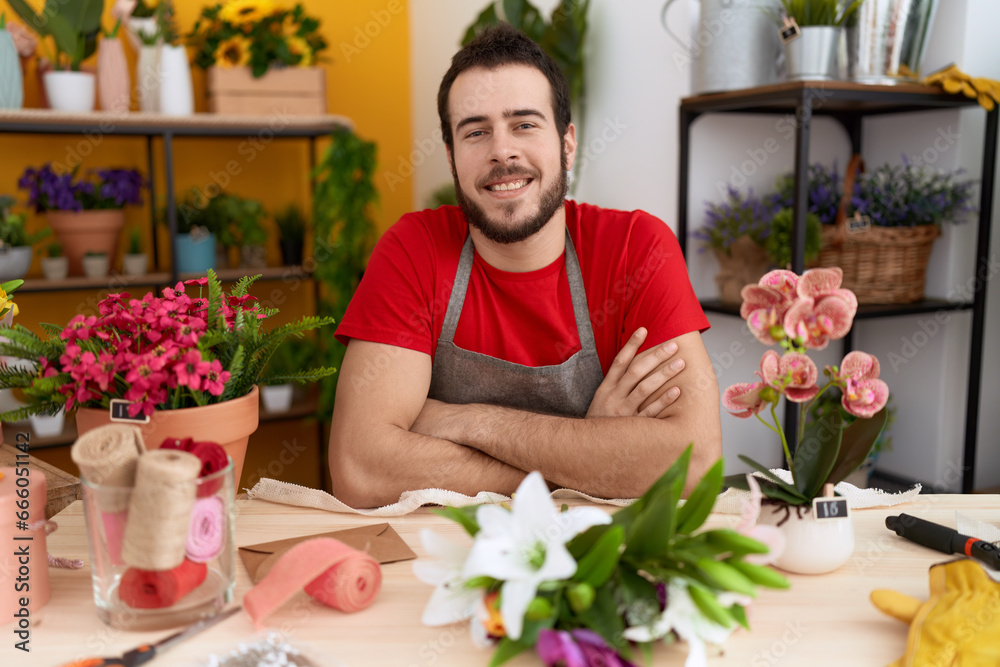Young hispanic man working at florist shop happy face smiling with crossed arms looking at the camera. positive person. Young hispanic man working at florist shop happy face smiling with crossed arms looking at the camera. positive person.