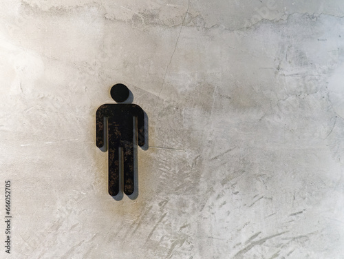 Black Men's Toilet Symbol on Grungy Concrete Wall