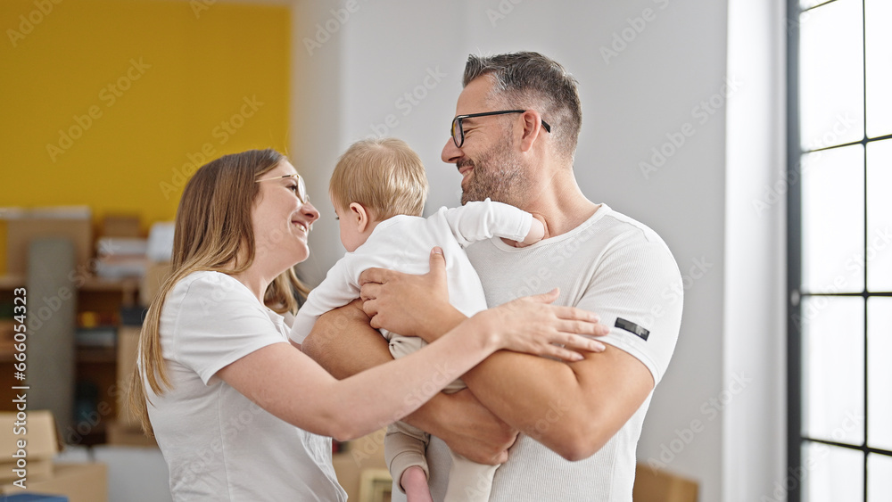 Fototapeta premium Family of mother, father and baby smiling together at new home