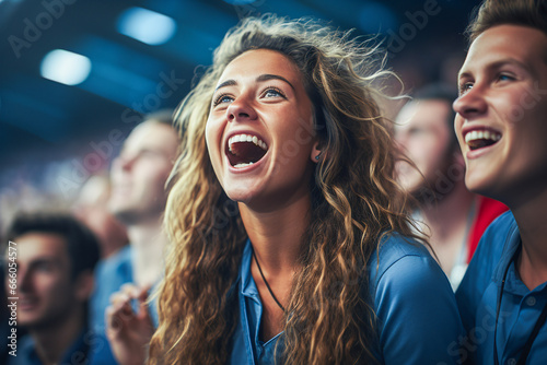 the world of soccer celebrating in a stadium showing cheering young brunette woman with long curly hairs  © bmf-foto.de