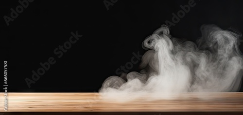Ethereal white smoke swirls on wooden table. Abstract black background. Mysterious patterns. Nighttime effect and mist. Enigmatic studio atmosphere