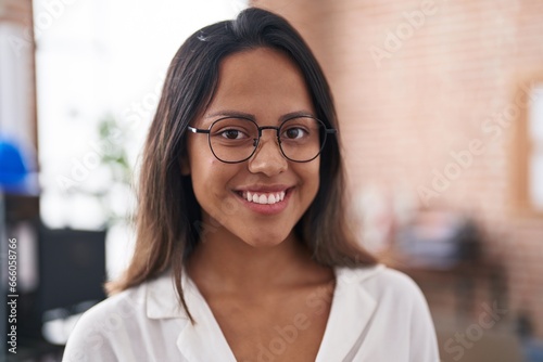 Young hispanic woman business worker smiling confident at office