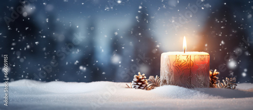 Christmas candle and snow as background photo