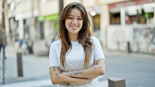 Free Download Young beautiful hispanic woman smiling confident standing with arms crossed gesture at street - GFXLoad