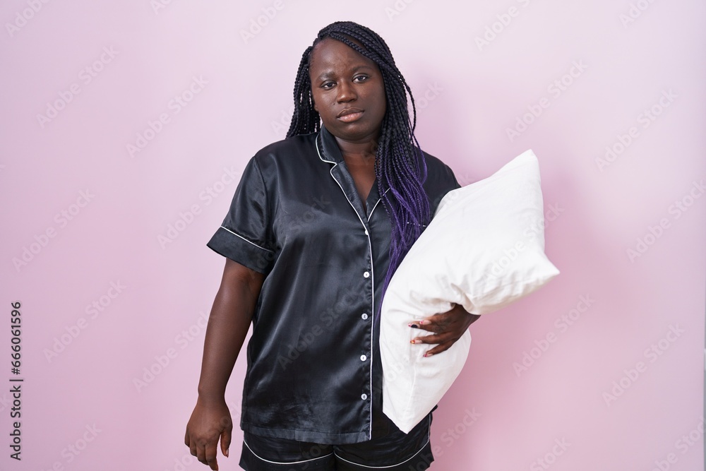 Φωτογραφία Young african woman wearing pijama hugging pillow looking sleepy and tired, exhausted for fatigue and hangover, lazy eyes in the morning