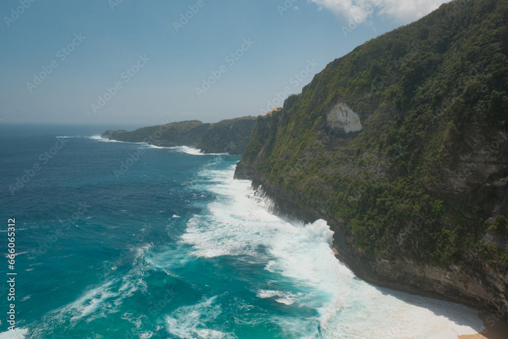 Cliff Range Overlooking Foamy Waters and the Serene Turquoise Shore of Nusa Penida