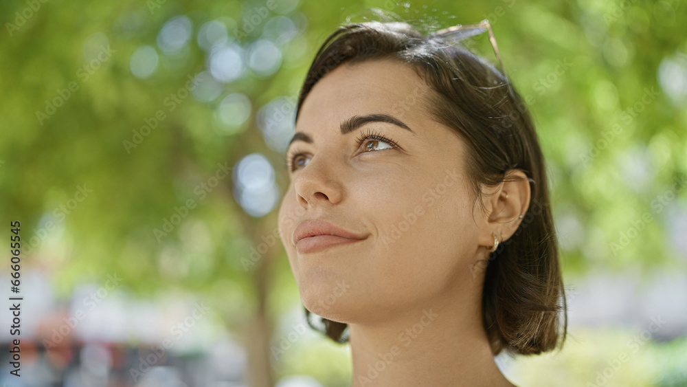Relaxed young hispanic woman, basking in the sunny park outdoors, looking at the sky with a beautiful expression, a cool casual lifestyle Relaxed young hispanic woman, basking in the sunny park outdoors, looking at the sky with a beautiful expression, a cool casual lifestyle