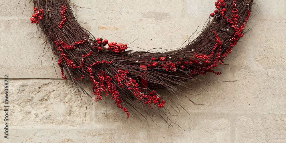 Φωτογραφία Modern interpretation of Ukrainian traditional protective amulet, talisman made of twigs and red berries on white stone wall