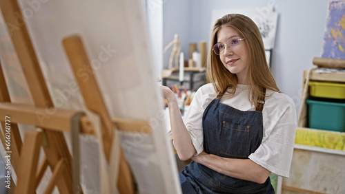 Young blonde woman artist smiling confident drawing at art studio © Krakenimages.com