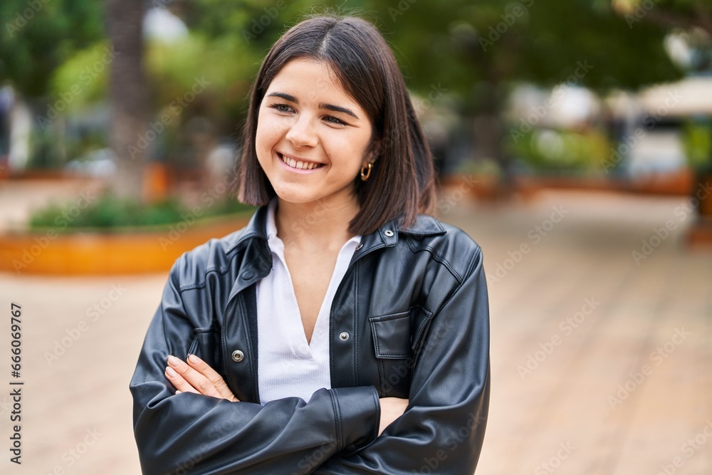 Young beautiful hispanic woman standing with arms crossed gesture at park Young beautiful hispanic woman standing with arms crossed gesture at park