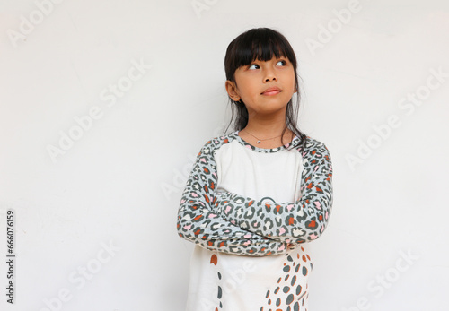 Curious cute girl wearing leopard sleeve pattern thinking to find an idea or inspiration. Intelligence kid concept