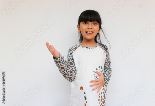 A happy little girl wearing leopard sleeve pattern raised her