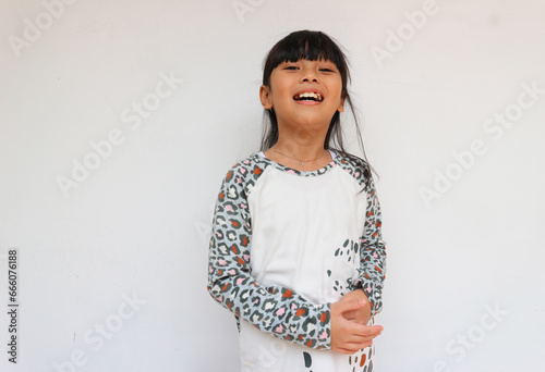 A happy little girl wearing leopard sleeve pattern