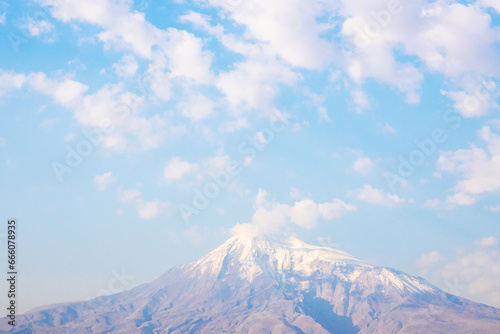view of top of Mount Ararat in autumn morning haze and white clouds in blue sky