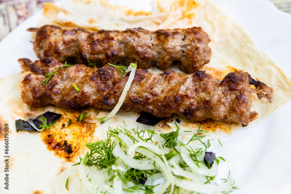 portion of kebabs on plate closeup in Armenian village outdoor restaurant
