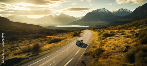 Car driving away on a road in a spectacular mountain settings photo