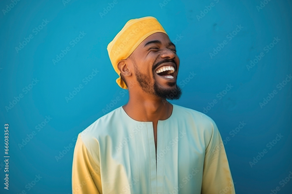 happy Moroccan man with typical moroccan tunic standing against blue wall happy Moroccan man with typical moroccan tunic standing against blue wall